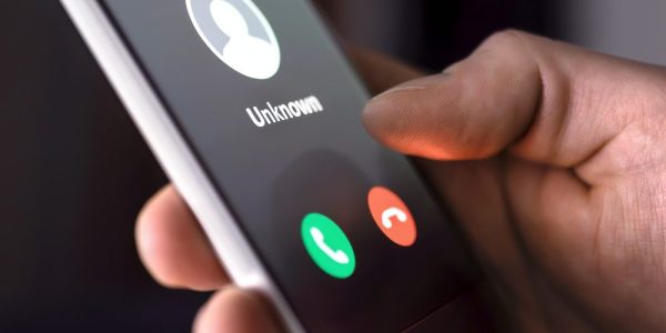 Phone call from unknown number late at night. Scam, fraud or phishing with smartphone concept. Prank caller, scammer or stranger. Man answering to incoming call.